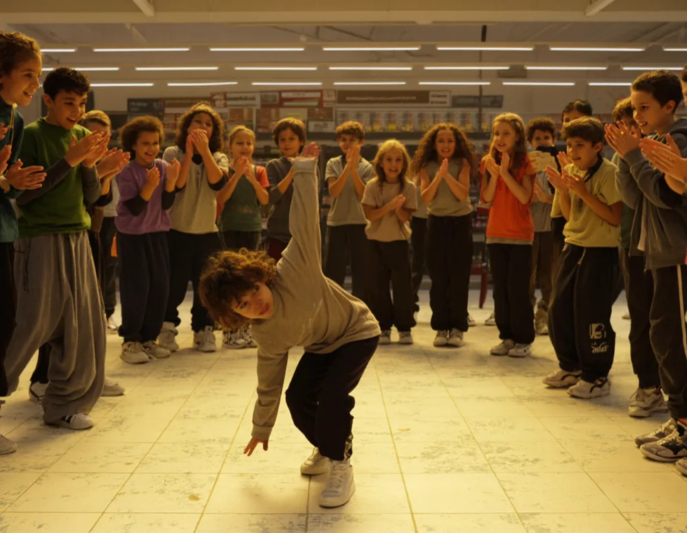 Kids Street: one child mid freeze while the rest of the class claps